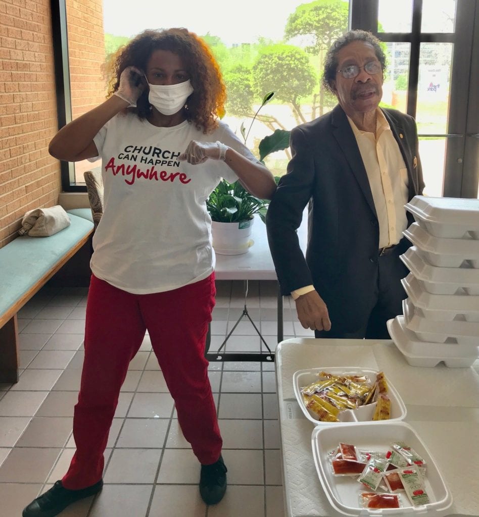 Community leader Thomas Jefferson (at right) stops by Hamilton Park UMC to thank the church for its feeding program. A volunteer next to him shows how the program is following CDC guidelines wearing masks and gloves.