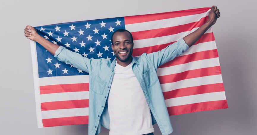 man in blue holding American flag